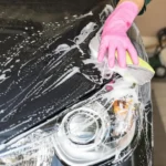 man cleaning his car What’s the Best Way to Wash Your Car at Home